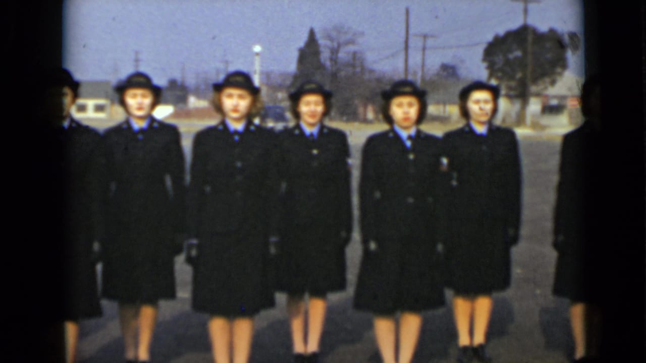 In 1947 New York footage, uniformed women in dark coats and hats face the camera in an outdoor formation.