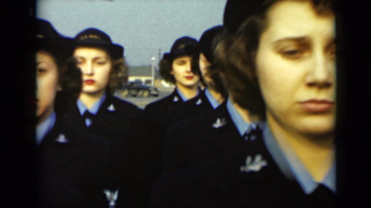 Uniformed women stand in rows, with one face close to the right edge.
