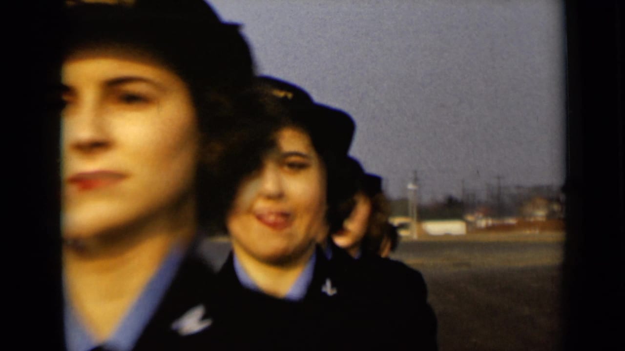 In 1947 New York footage, women in U.S. Navy caps and dark jackets approach the camera across an open paved area.