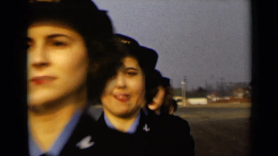 In 1947 New York footage, women in U.S. Navy caps and dark jackets approach the camera across an open paved area.