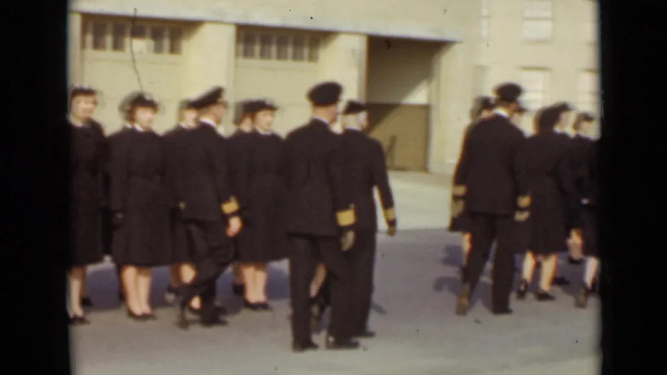The formation continues across the paved area, with uniformed participants seen from behind and the side in 1947 New York.