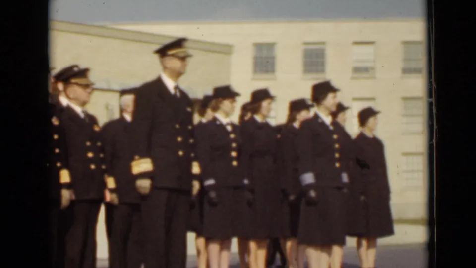 The final frame shows the formation continuing along the building, with dark service uniforms, caps, and gold trim visible.