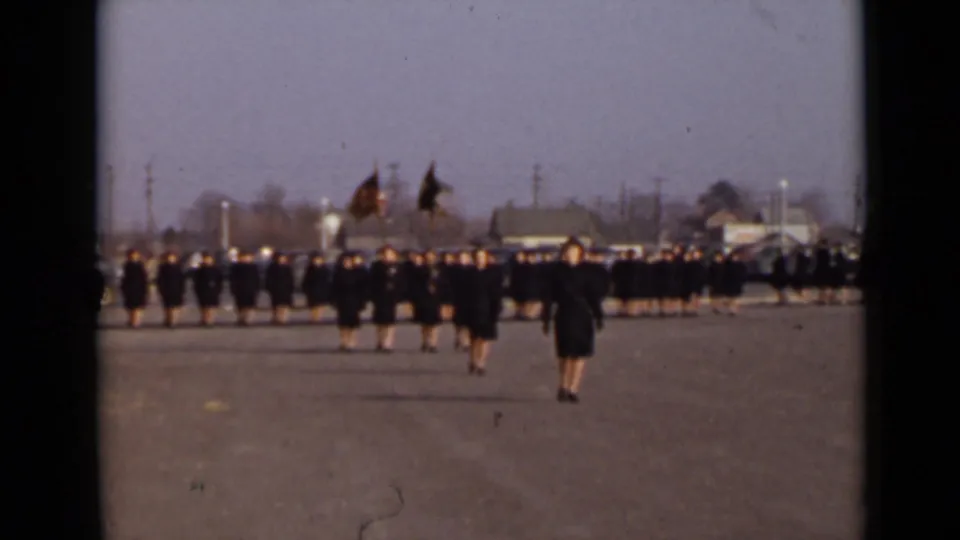 The formation fills the background while a few uniformed women stand forward on the open paved ground during the 1947 New York ceremony.