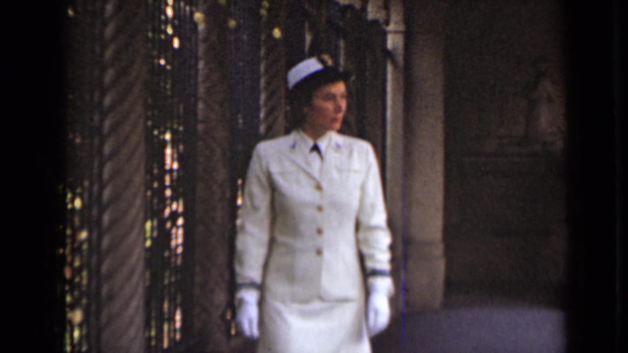 1947 New York footage shows a uniformed woman in white gloves walking through an ornate interior with columns and a dark screen.