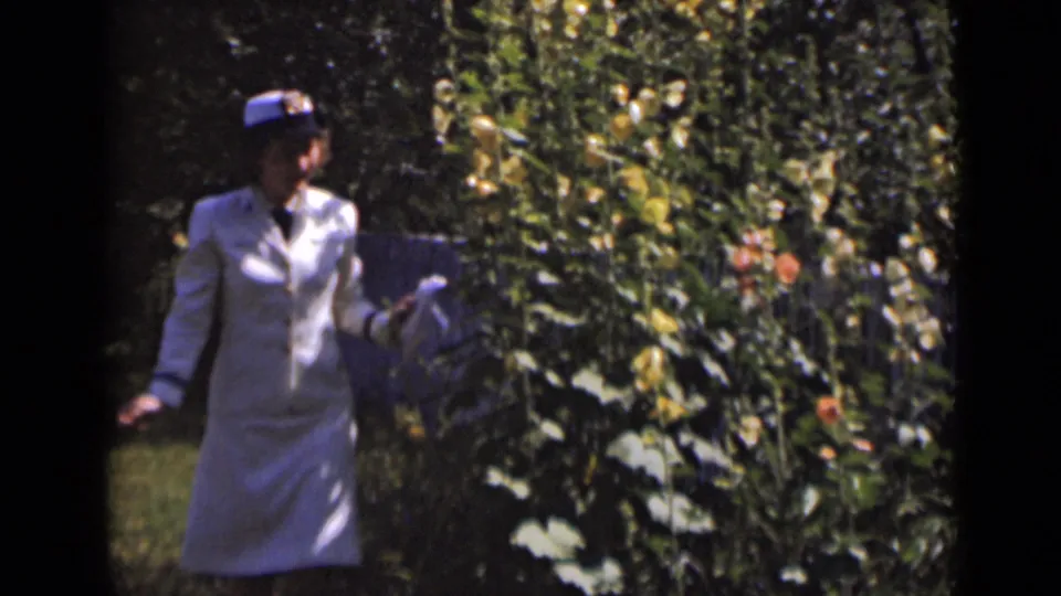 At the end of the brief 1947 New York garden clip, the woman remains near the flowering plants as the handheld frame holds on her gesture.