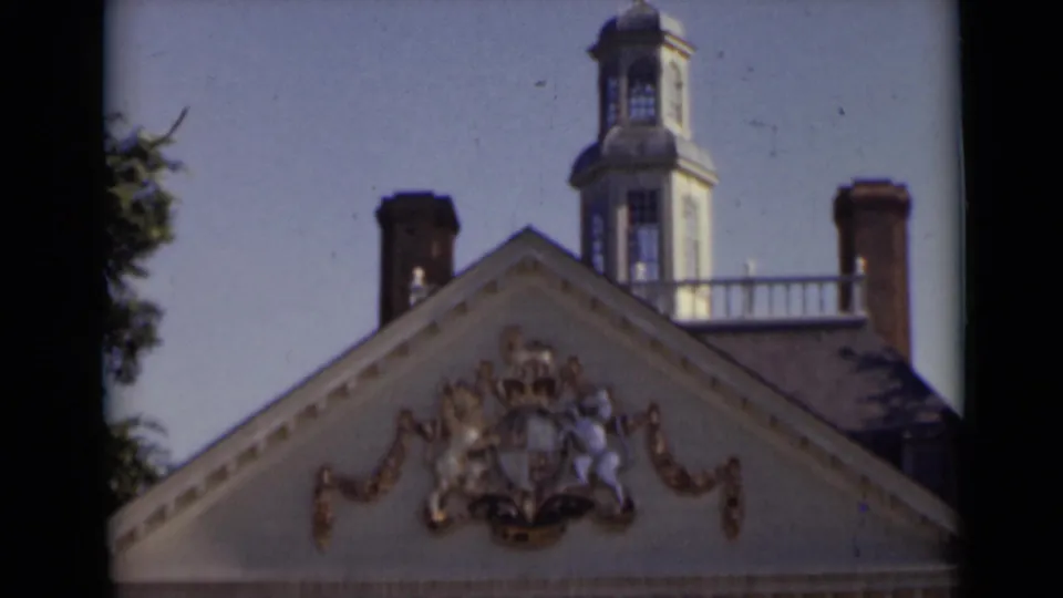 A second 1947 New York view of the same ornate roof, with gold-toned heraldry, chimneys, and a rooftop watch tower in soft 8mm color.