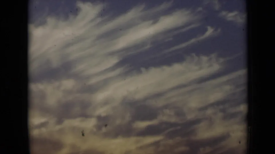 1947 New York 8mm frame with layered pale clouds moving across a darker blue and purple sky field.