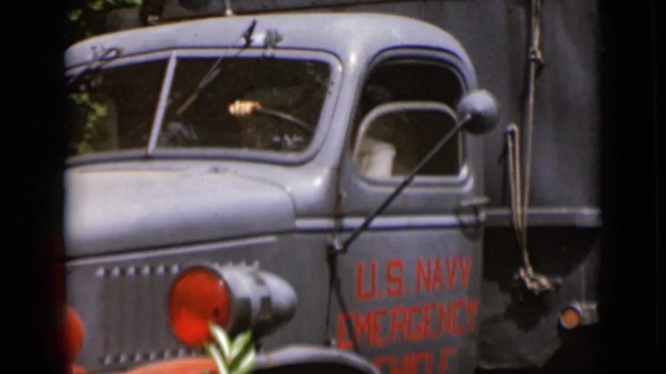 The final frame shows the gray U.S. Navy emergency vehicle from the side, with the cab window open and lettering partly cropped.