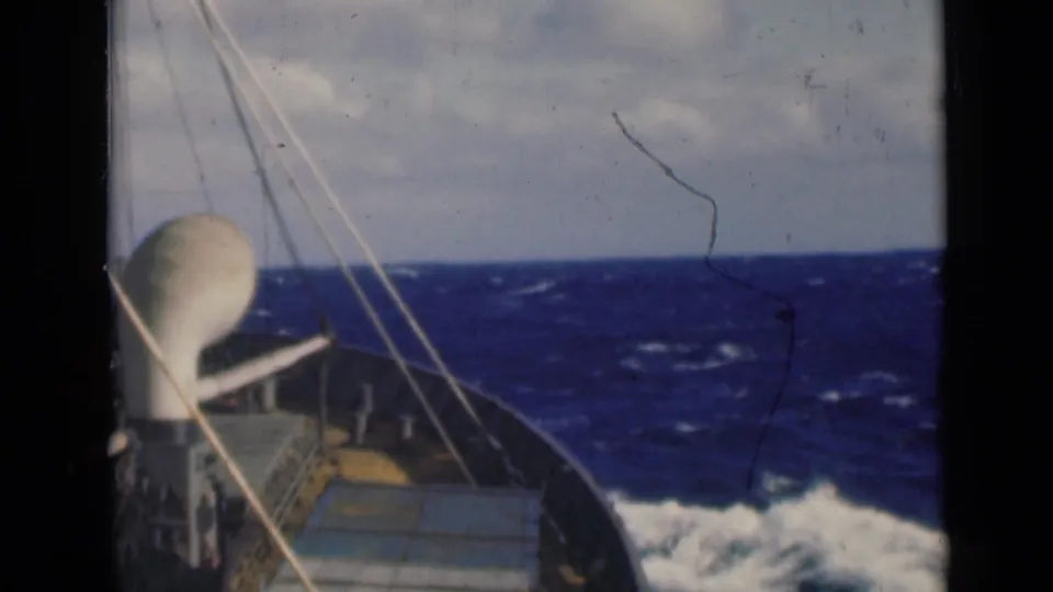 Ship deck view from the 1947 clip, with rigging crossing the frame and rough sea visible beyond the bow.