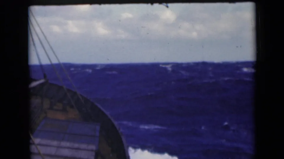 Final 8mm frame of the vessel bow and rigging facing choppy blue water, consistent with the 1947 Persian Gulf metadata.