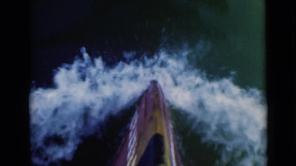1946 8mm frame showing a first-person board-level view moving through foamy surf near the Suez Canal, Egypt.