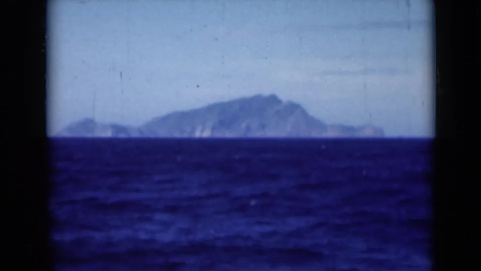 A soft 8mm view shows deep blue water and a distant coastal landmass, likely filmed from the Suez Canal area in 1946.