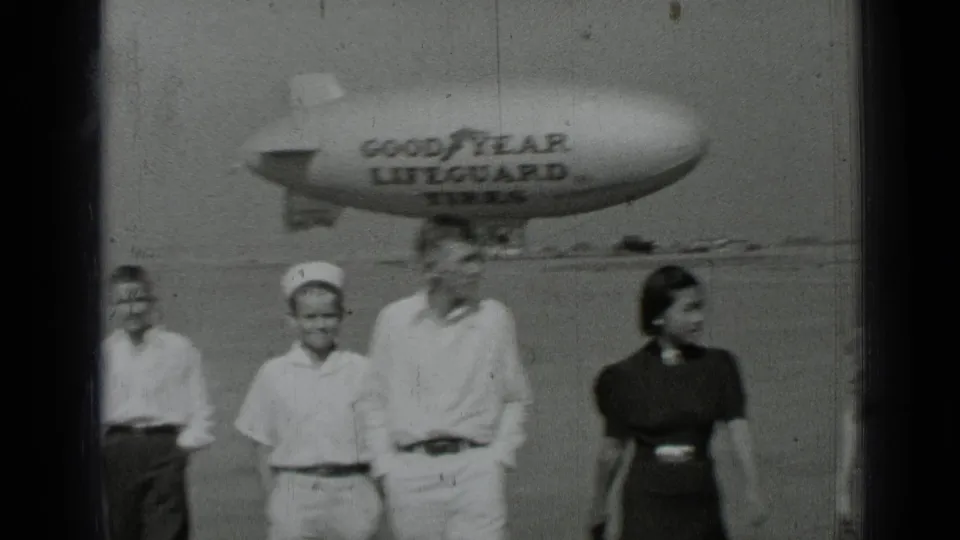 Near the end of the 1937 San Francisco clip, the group is close to camera and the Goodyear blimp softens in the background.