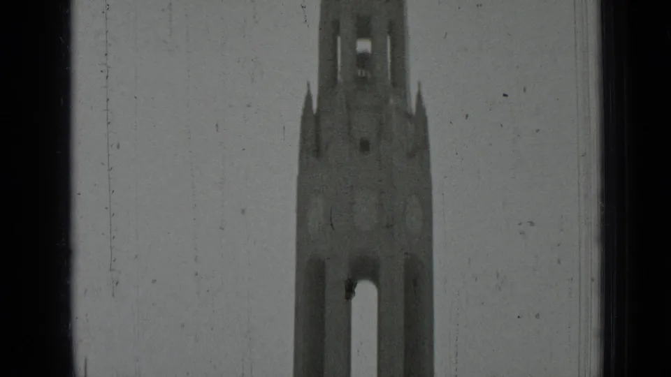 1937 San Francisco 8mm frame showing the upper bell tower section against a pale sky, bordered by dark window or film-frame edges.