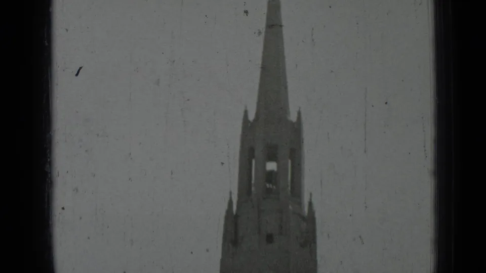 1937 San Francisco 8mm frame with the cathedral spire and upper bell tower visible through a dark-edged frame.
