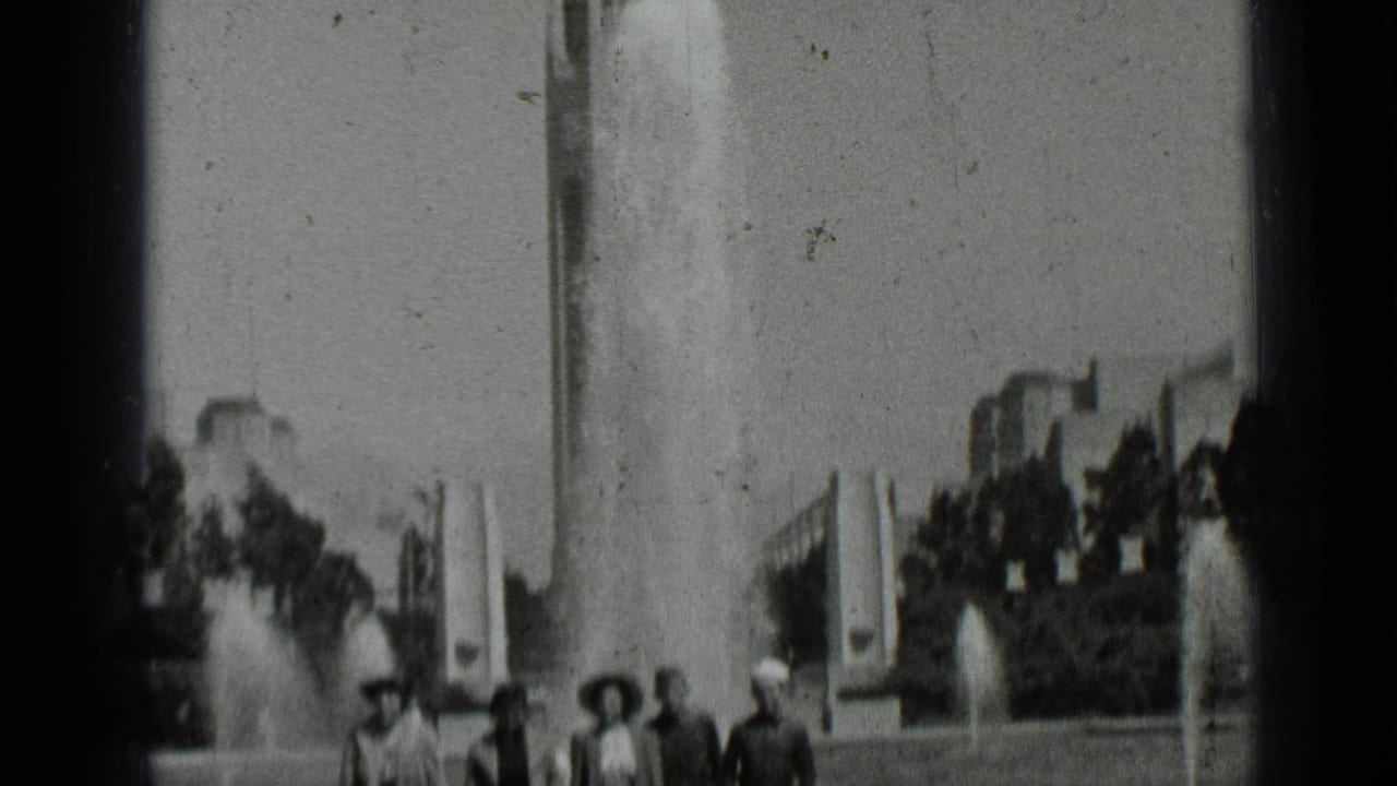 People partly framed at the bottom near fountains and tall structures.
