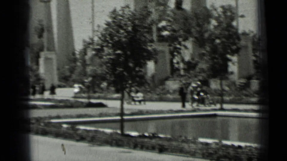 1937 San Francisco park view with trees, a fountain basin, walkways, and small figures in the distance.