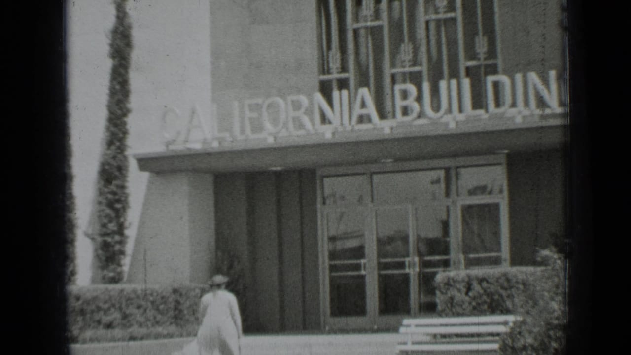 Closer 1937 San Francisco 8mm view of the California Building entrance, with the woman walking into the lower part of the frame.