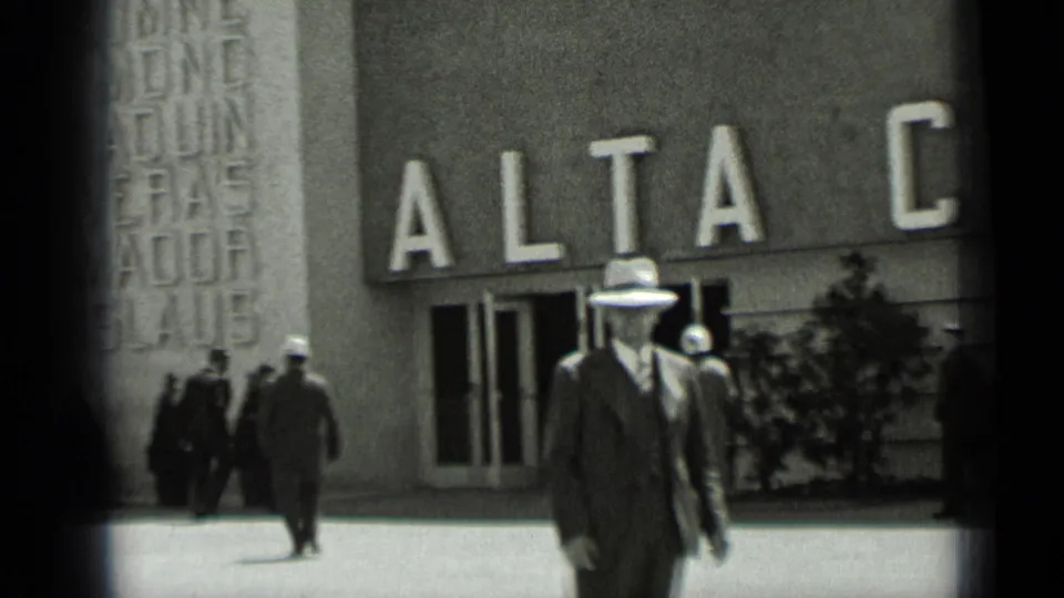 1937 San Francisco street-level view of adult men in suits and hats passing a facade marked with large ALTA letters.
