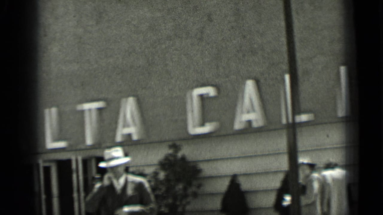 Men in hats pass below large ALTA CALIFORNIA facade lettering.