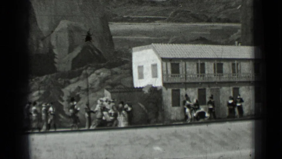 1937 San Francisco frame showing costumed figures beside a staged building facade, rocks, and painted landscape scenery.