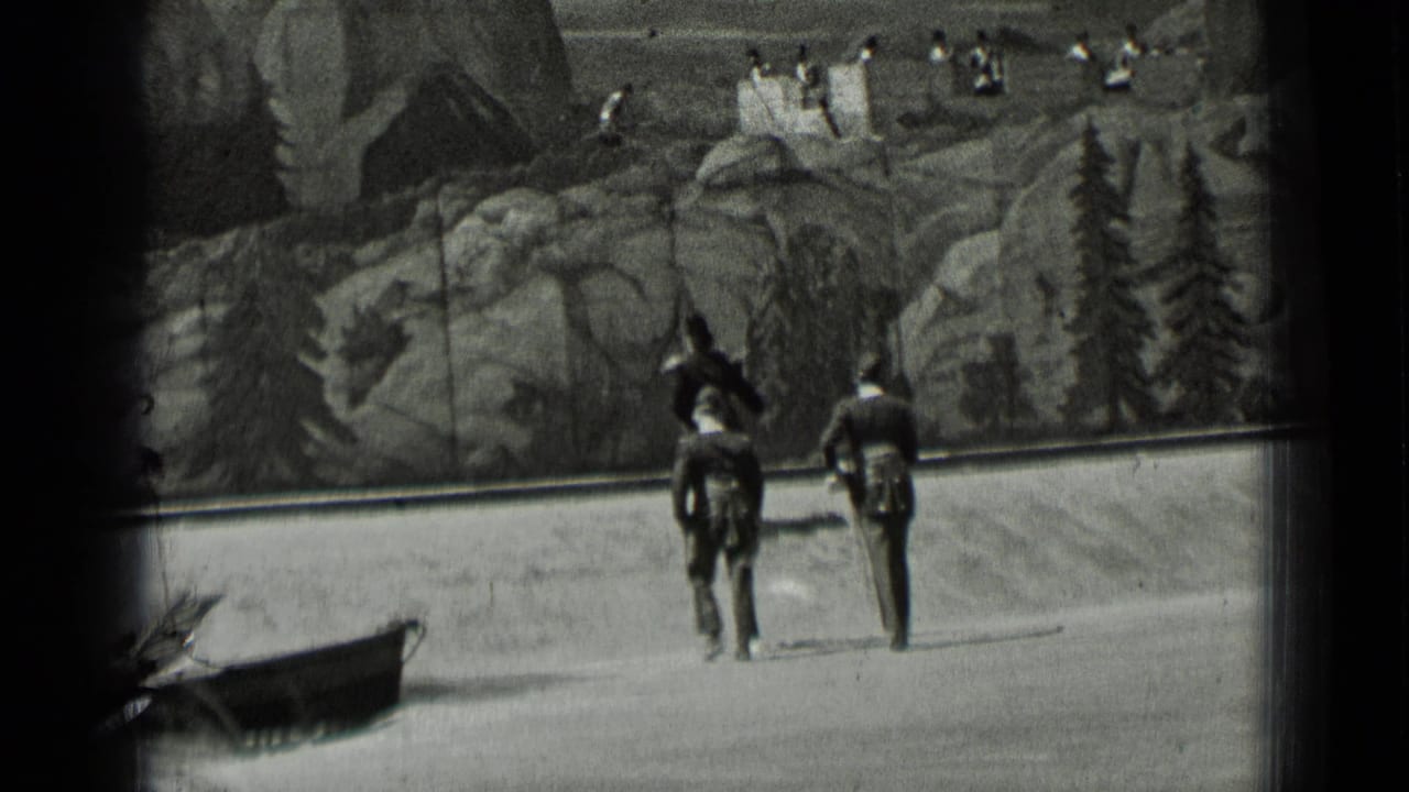 Two dark-uniformed figures walk side by side in front of a painted landscape backdrop.