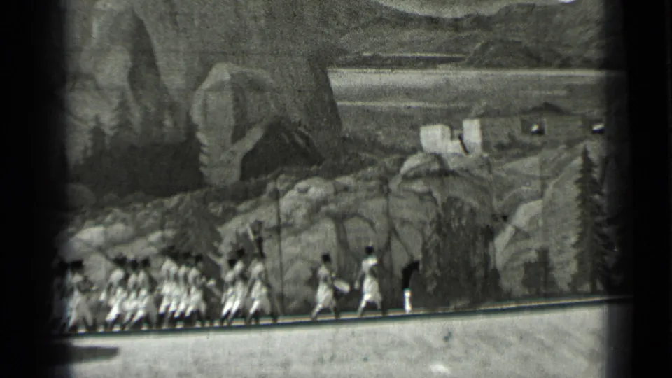 End frame from the 1937 San Francisco clip showing marchers and a drummer against painted mountain scenery.