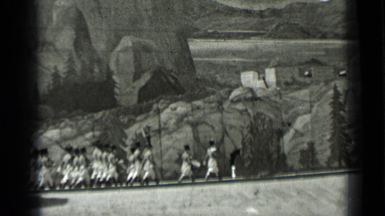 Line of women continues running beside rocks and painted scenery.