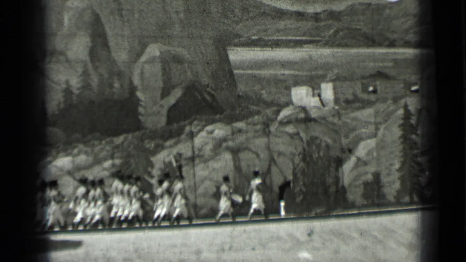 Costumed performers appear in profile on a 1937 San Francisco studio set with painted rocks, shrubs, and cabin forms behind them.