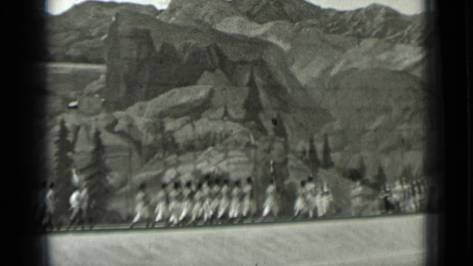 Final frame shows a compact group of uniformed marchers at the base of rocky scenic terrain in the San Francisco 1937 home movie.
