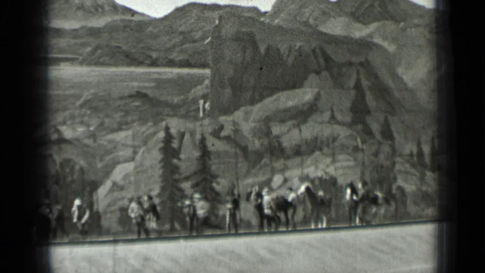1937 San Francisco home-movie frame with costumed performers, horses, and a painted mountain backdrop in a staged Western reenactment.