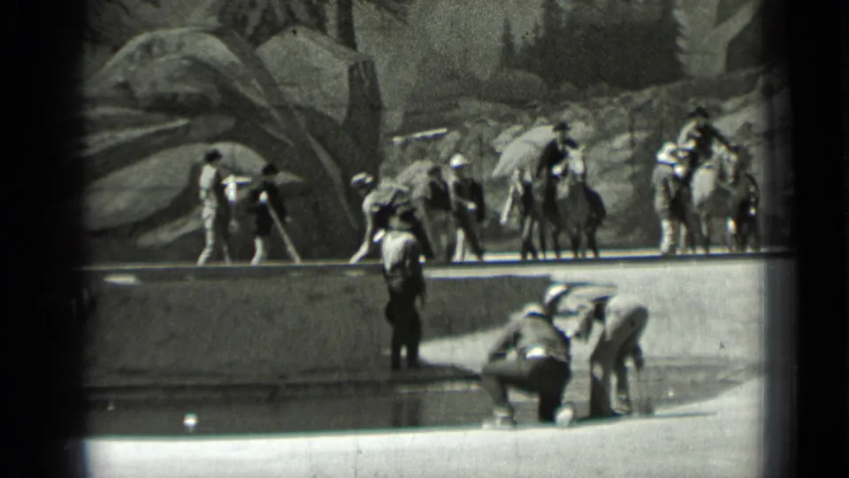1937 San Francisco work-camp view with crouching foreground workers, horseback riders, and laborers near a rocky landscaped area.