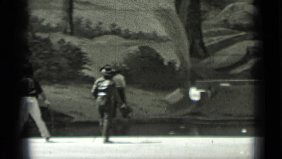 In 1937 San Francisco home-movie footage, two costumed figures pass in front of a painted frontier-style backdrop.