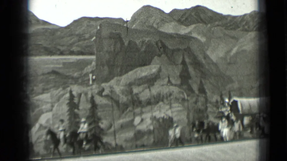 A staged frontier scene shows painted mountains, rocky scenery, costumed figures, and covered wagons in the 1937 San Francisco clip.