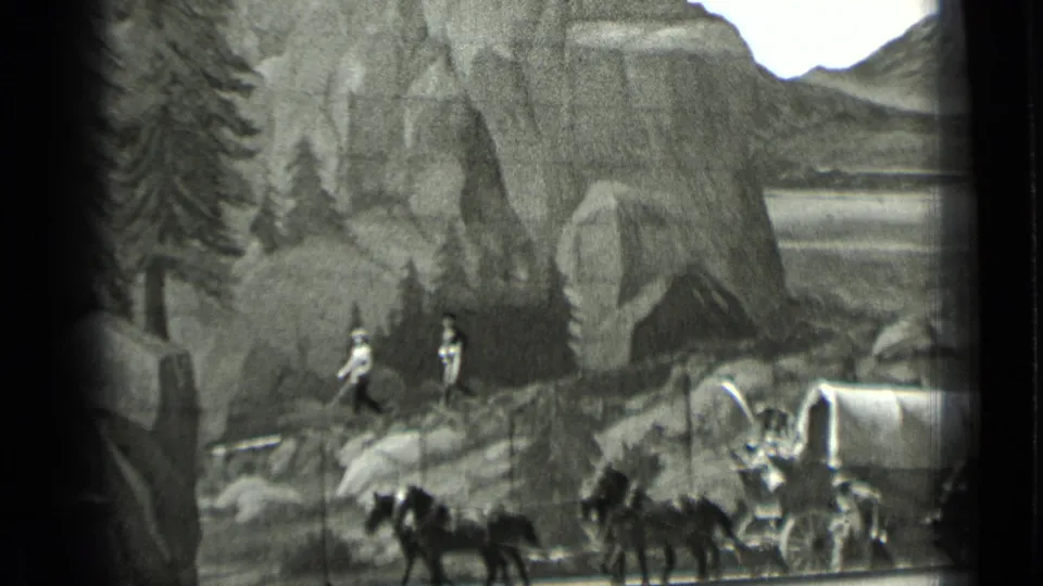 Horse-drawn covered wagon and performers cross a theatrical Western set in 1937 San Francisco footage.