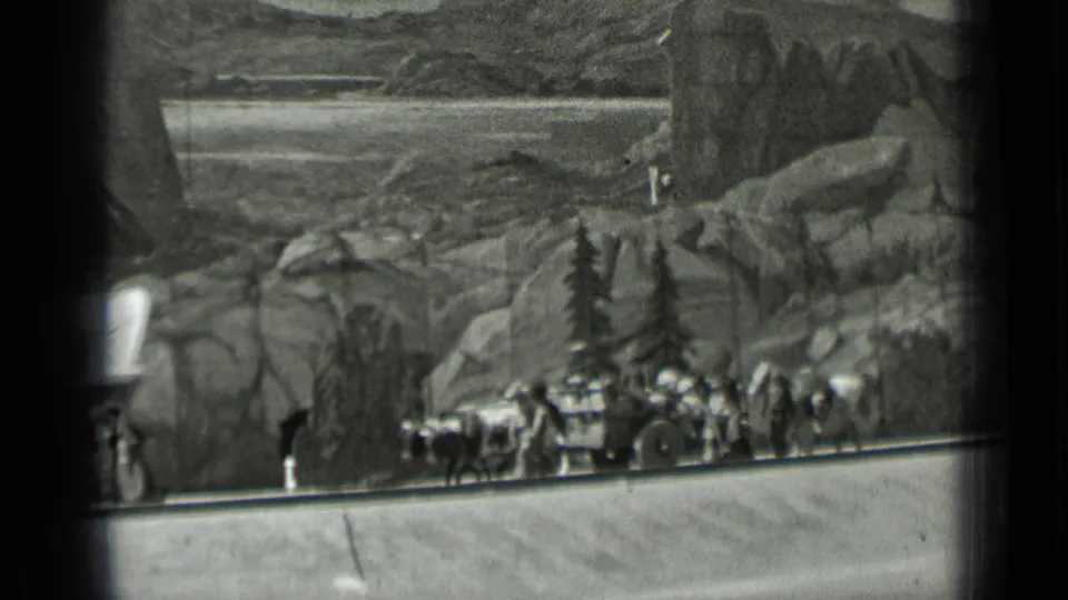1937 San Francisco home-movie frame showing the diorama caravan farther along the display path with oxen and travelers.