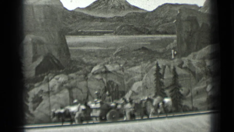 Black-and-white 1937 San Francisco frame with horses, wagon, and visitors moving along a path before scenic mountains.