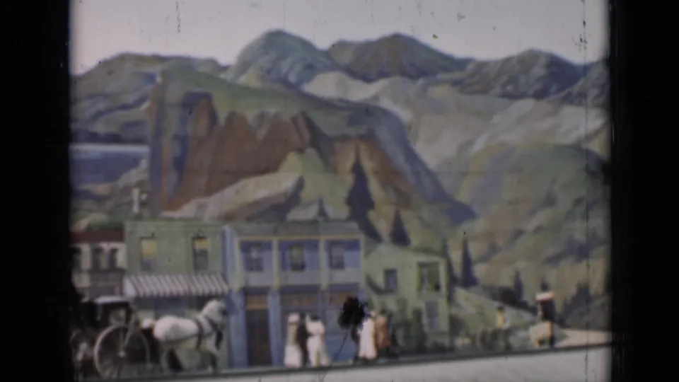 1937 San Francisco frame with a horse-drawn carriage, pedestrians, painted storefronts, and a mountain backdrop in a staged scene.