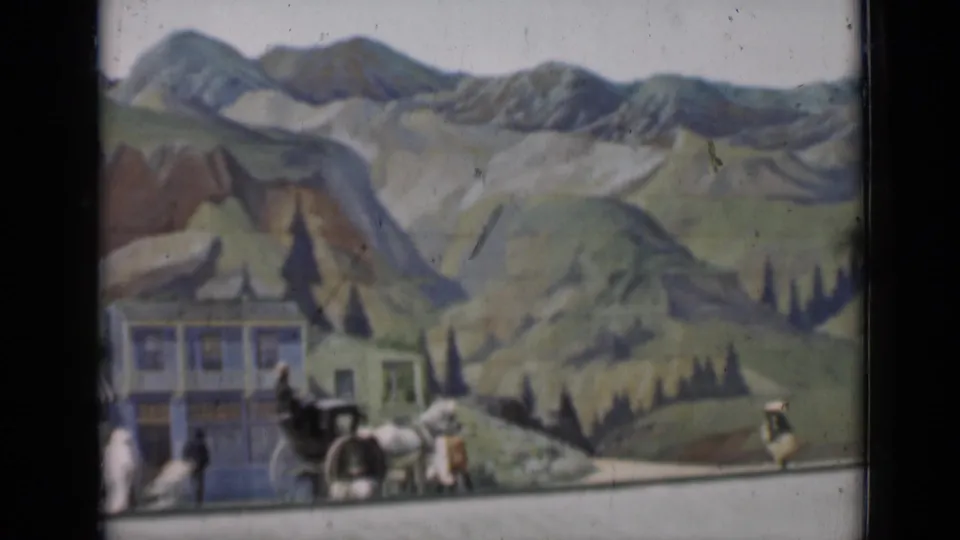 1937 San Francisco frame with a horse-drawn carriage, a pedestrian, painted false-front buildings, and layered mountain scenery.