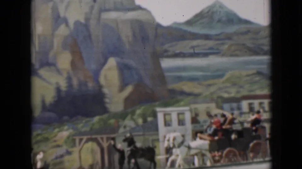 1937 San Francisco frame showing a carriage and pedestrians before a scenic painted backdrop with rock arch, water, hills, and a distant peak.