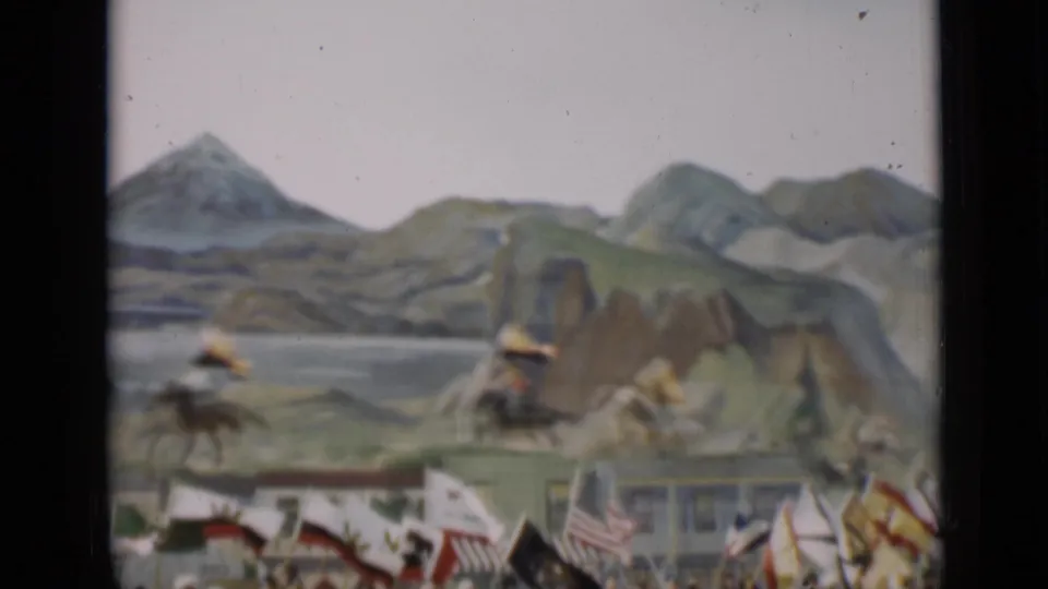 1937 San Francisco 8mm frame showing parade riders, flags, and a scenic painted mountain backdrop.