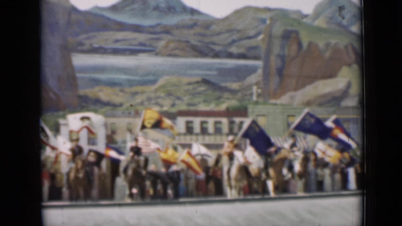 1937 San Francisco parade footage shows flags, riders, and wagon-like vehicles in front of painted lake and mountain scenery.