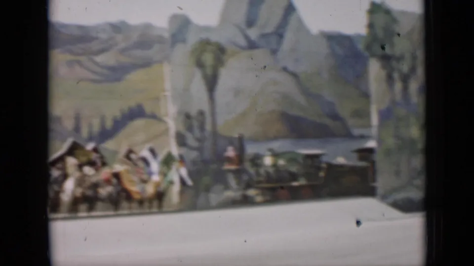 A small train display appears beside the tail of a mounted flag procession in 1937 San Francisco footage.