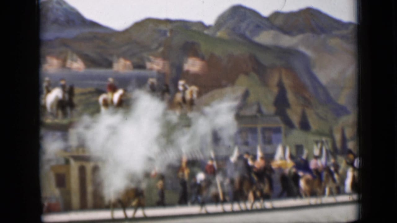 Parade riders and walkers move past the miniature train and painted hills in the 1937 San Francisco Frontier West display.