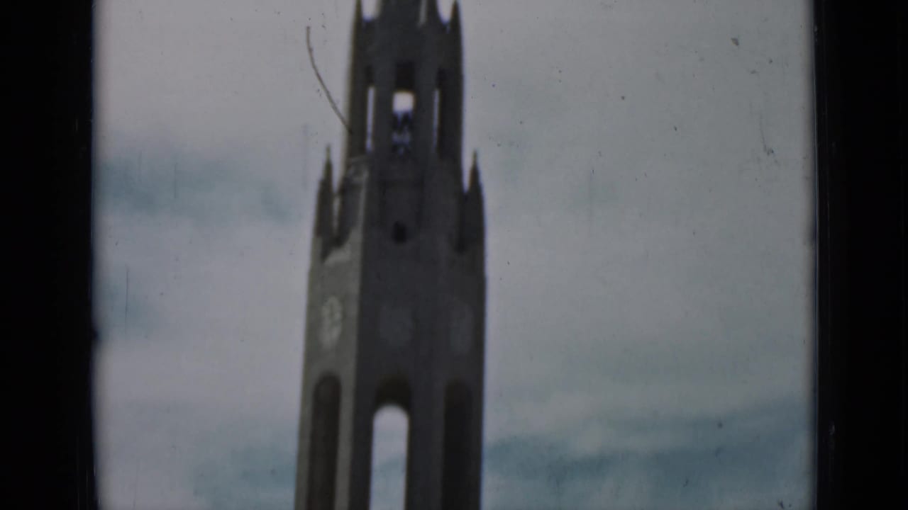 The final frame holds on a Gothic-style tower or spire, likely part of a church or cathedral, in grainy 1937 San Francisco footage.