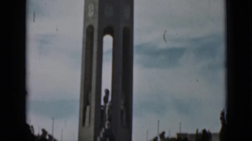 1937 San Francisco frame with the monument tower, central statue, low landscaping, and cloudy sky.