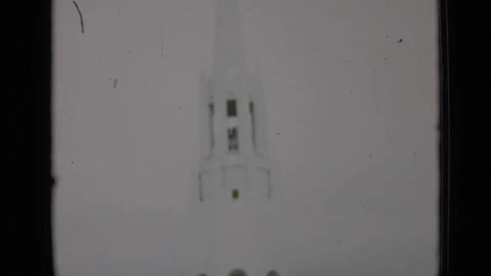 Soft 8mm view of a tall pale monument or tower in the supplied San Francisco 1937 clip.