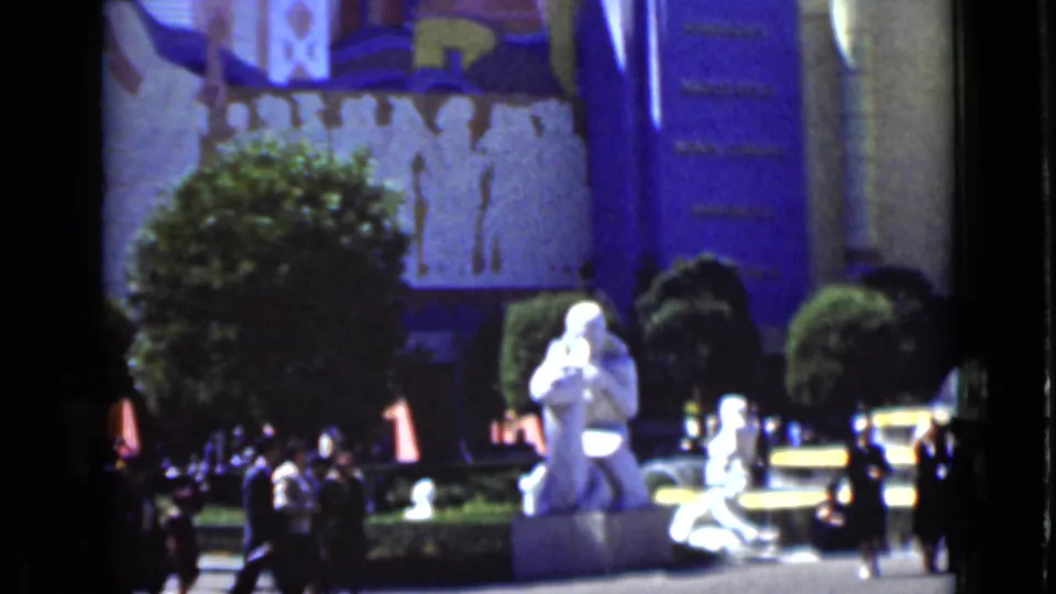 1937 San Francisco attraction scene with a white statue, trimmed greenery, visitors, and decorative architecture in the background.
