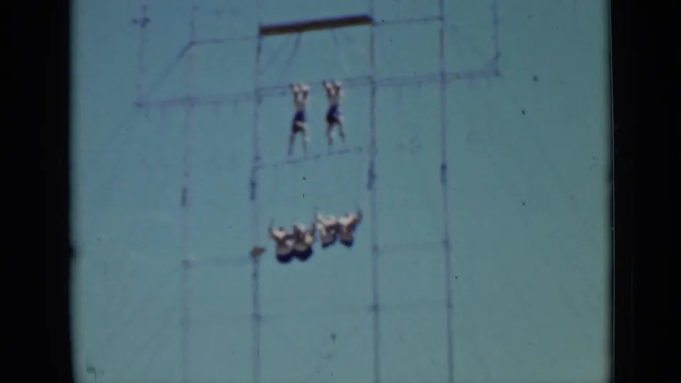 Final 1937 San Francisco frame with high-rope acrobats and a lower formation on outdoor aerial equipment.