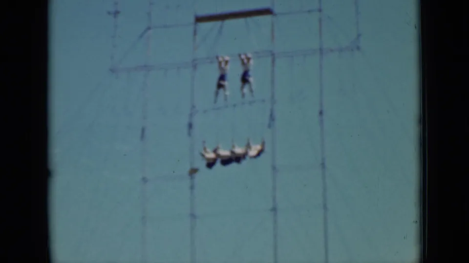 1937 San Francisco 8mm frame showing an aerial act with four performers suspended below a pair on the upper structure.